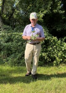 Phil Boucher holding a tree branch.